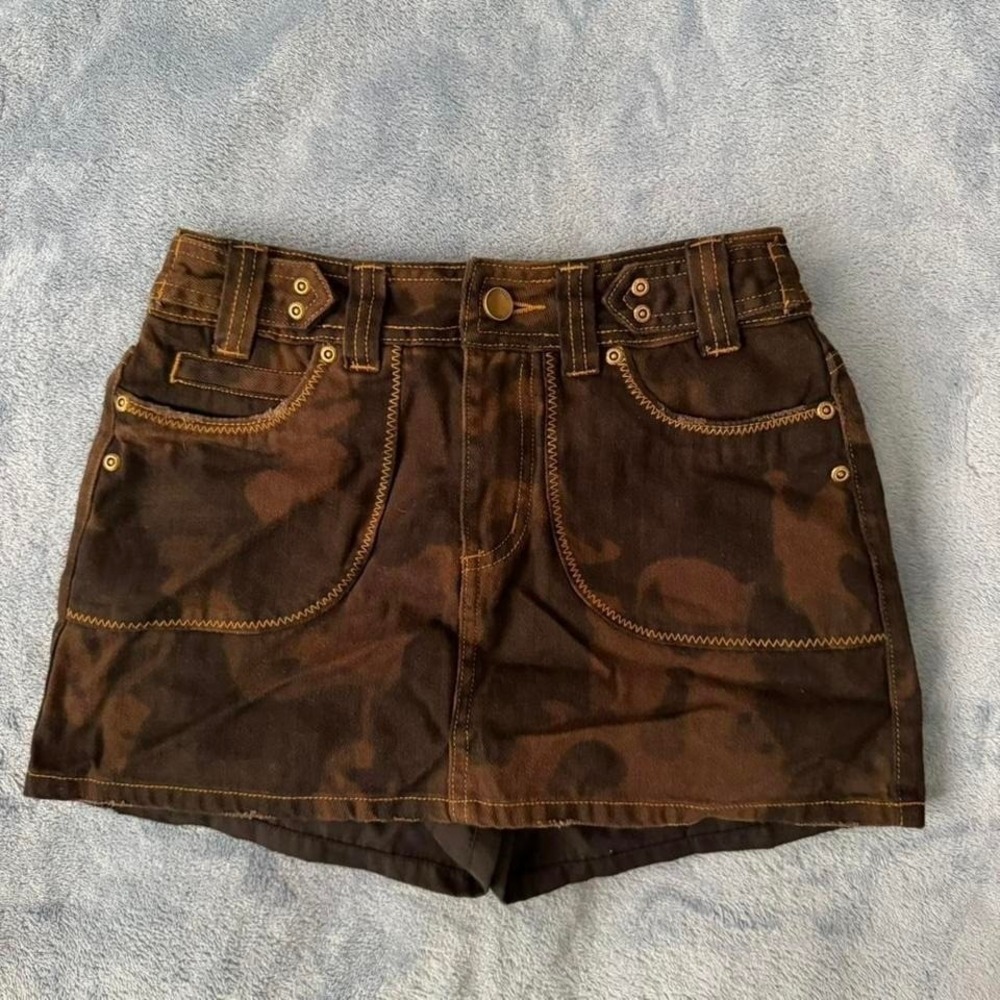 Brown camo denim shorts with button fly and pockets. Women Size: S